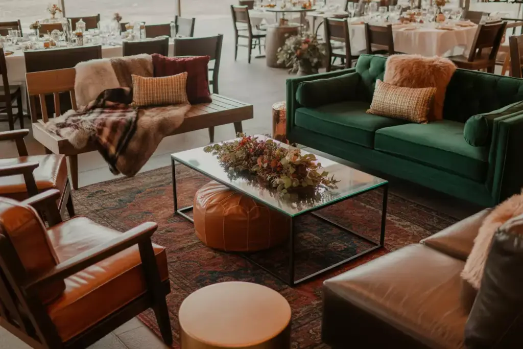 Cozy lounge area velvet sofa faux fur plaid blankets autumn