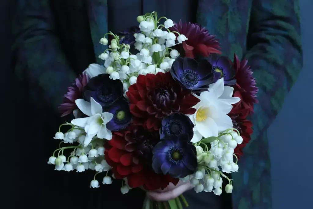 High contrast bouquet white lily of the valley burgundy dahlia