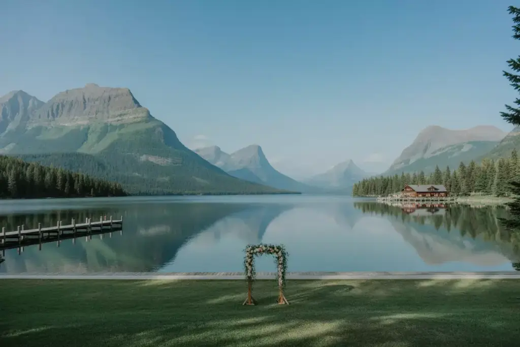 Serene lake mcdonald ceremony view with lodge and mountain reflections