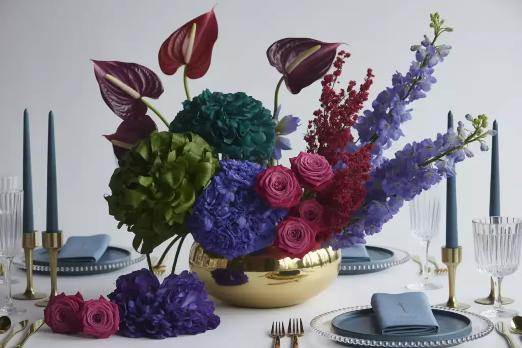 Jewel toned anthurium amaranth delphiniums gold vessel