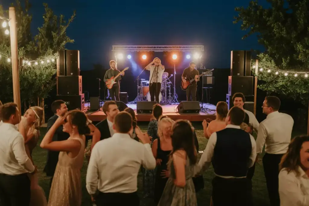 Live band performing on stage at outdoor wedding reception