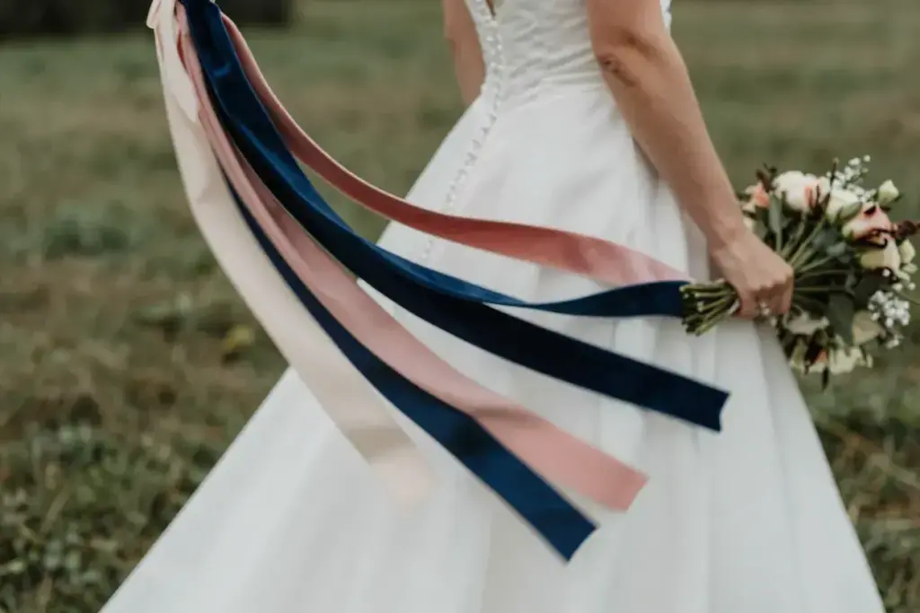 Trailing ribbon bouquet flowing in outdoor breeze bride
