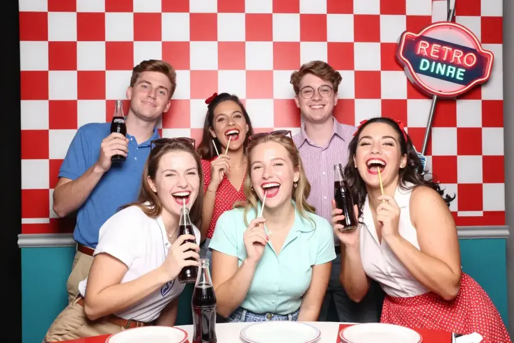 Retro diner booth with checkered pattern soda bottles and neon