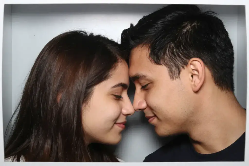The forehead touch intimate couple pose in photo booth