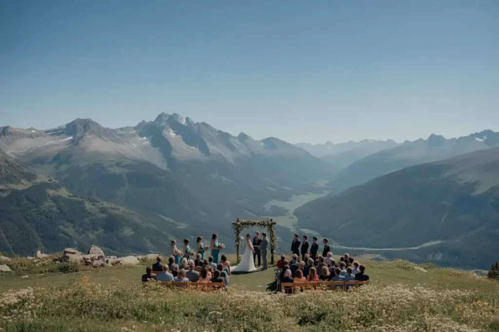 Alpine meadow wedding with snowcapped mountain panorama backdrop