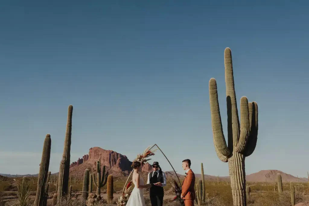 Modern wedding ceremony among saguaro cacti and red rocks