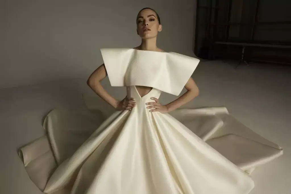 Structured dramatic square neck wedding gown architectural shoulders train