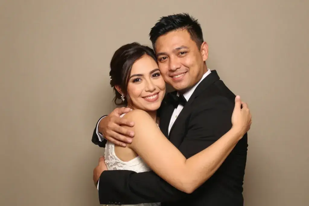 The gentle embrace couple warm hug photobooth smiles