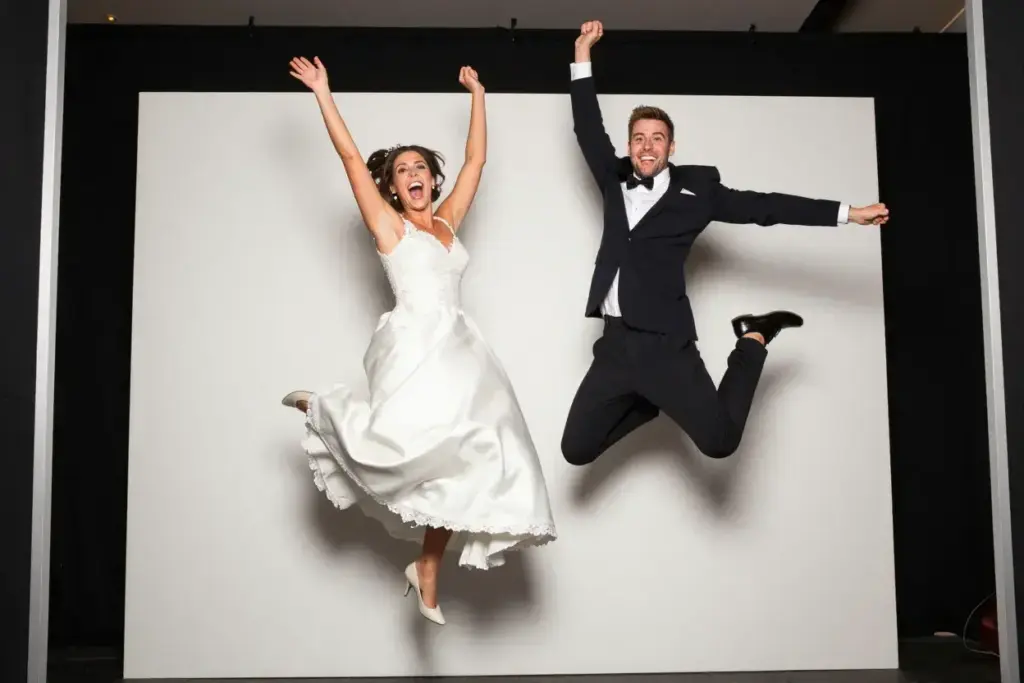 The jump shot couple mid air celebratory photobooth pose