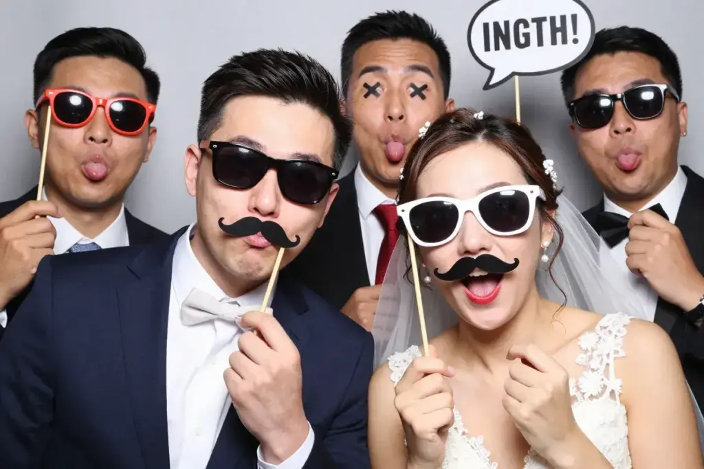 Silly faces props couple goofy sunglasses mustaches photobooth