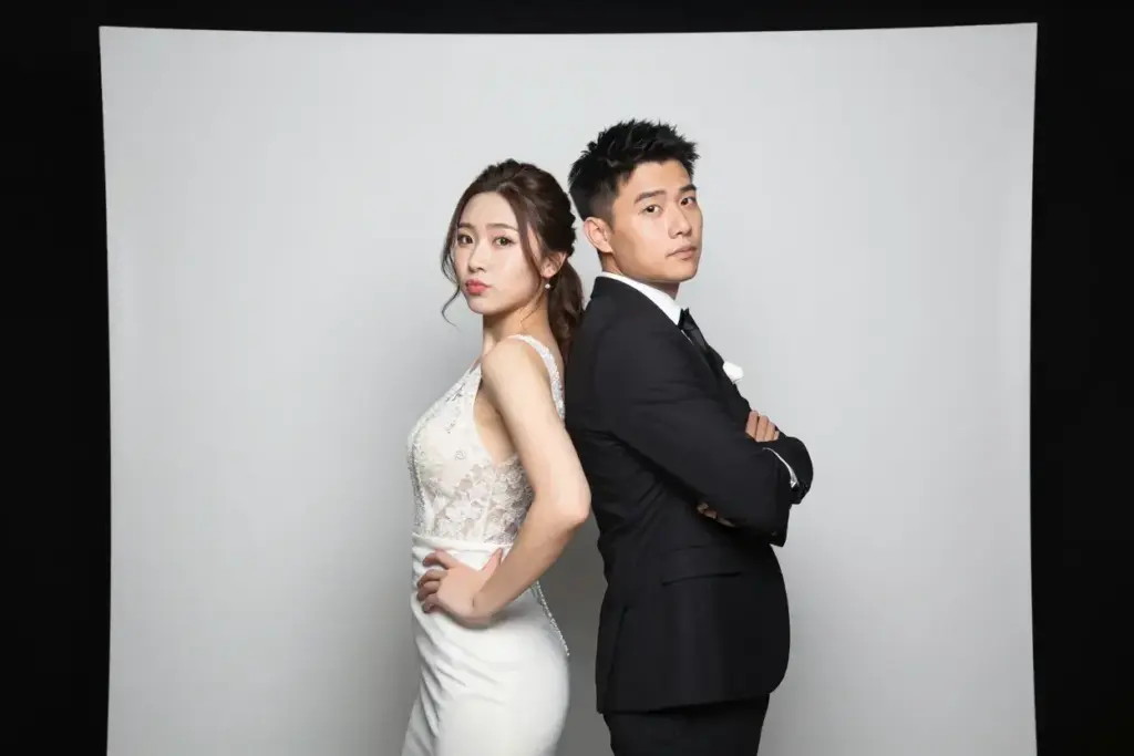 The back to back pose couple shoulder glance photobooth style