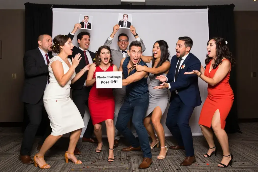 Large group doing a pose recreation challenge at lively photo booth