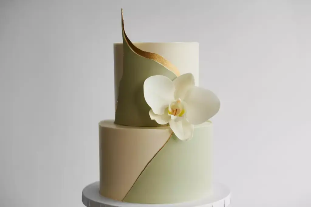 Minimalist tiered cake with single orchid and clean lines