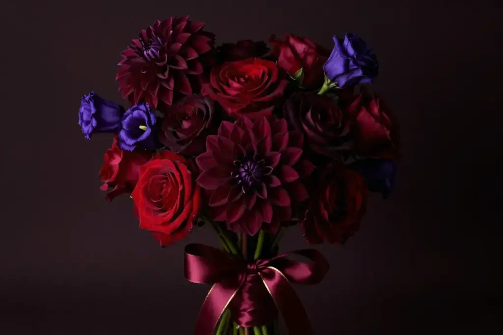 Dramatic burgundy bouquet dahlias roses gold ribbon