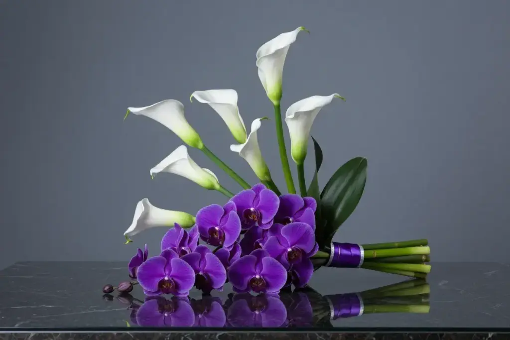 Modern arrangement of purple orchids and white calla lilies