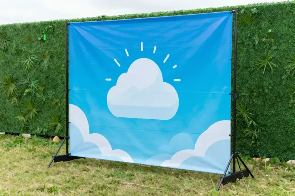 Durable vinyl backdrop on weighted telescoping stand outdoors