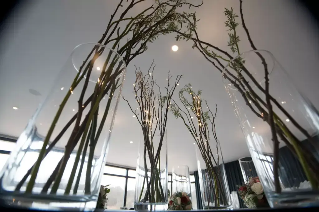 Tall glass cylinders with elegant curly willow branches inside