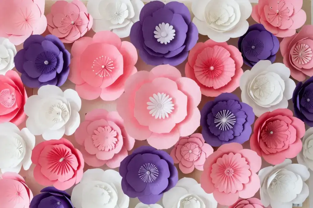 Close up textured wall of multicolored handmade tissue paper flowers