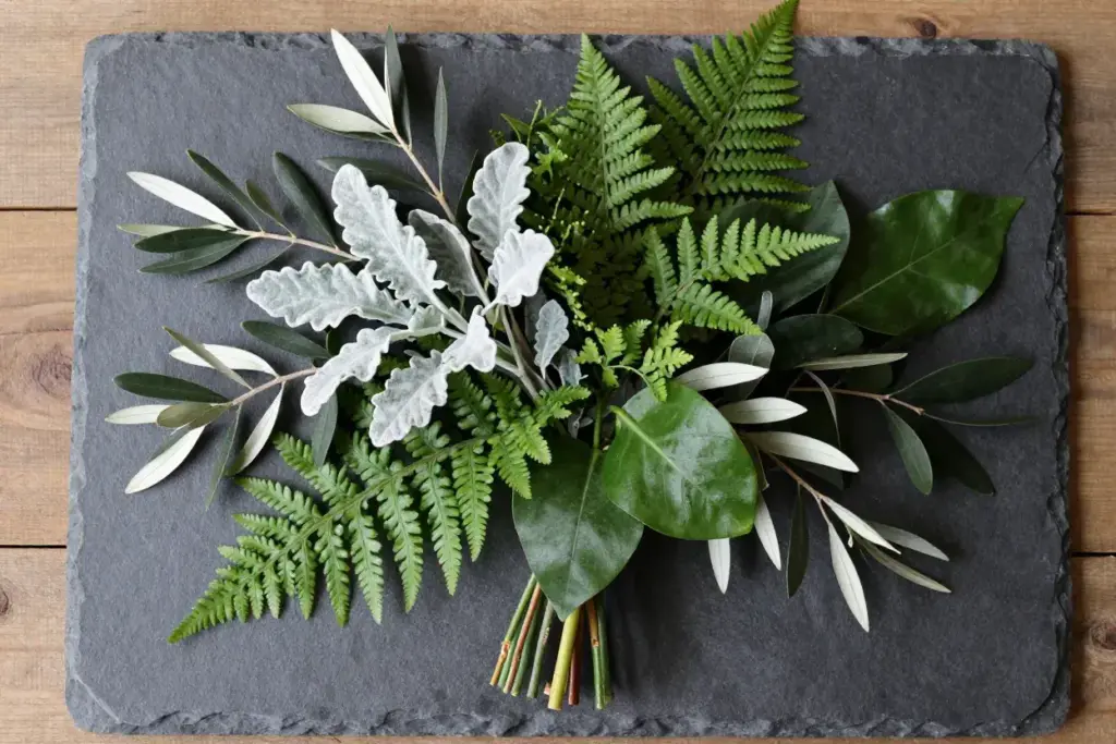 Textured greenery only bouquet flat lay with dusty miller
