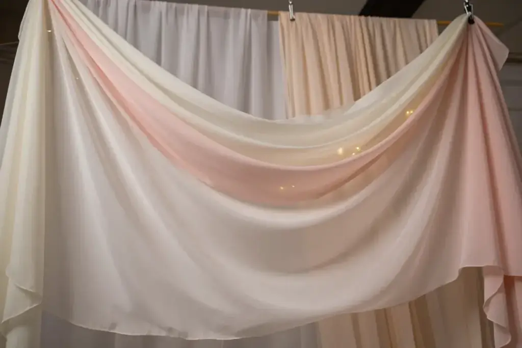 Flowing fabric draping backdrop with string lights