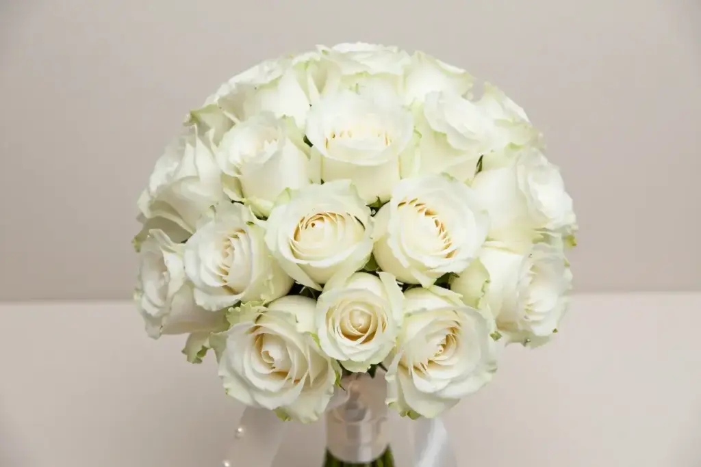 White garden rose posy with ivory ribbon pearl pins studio