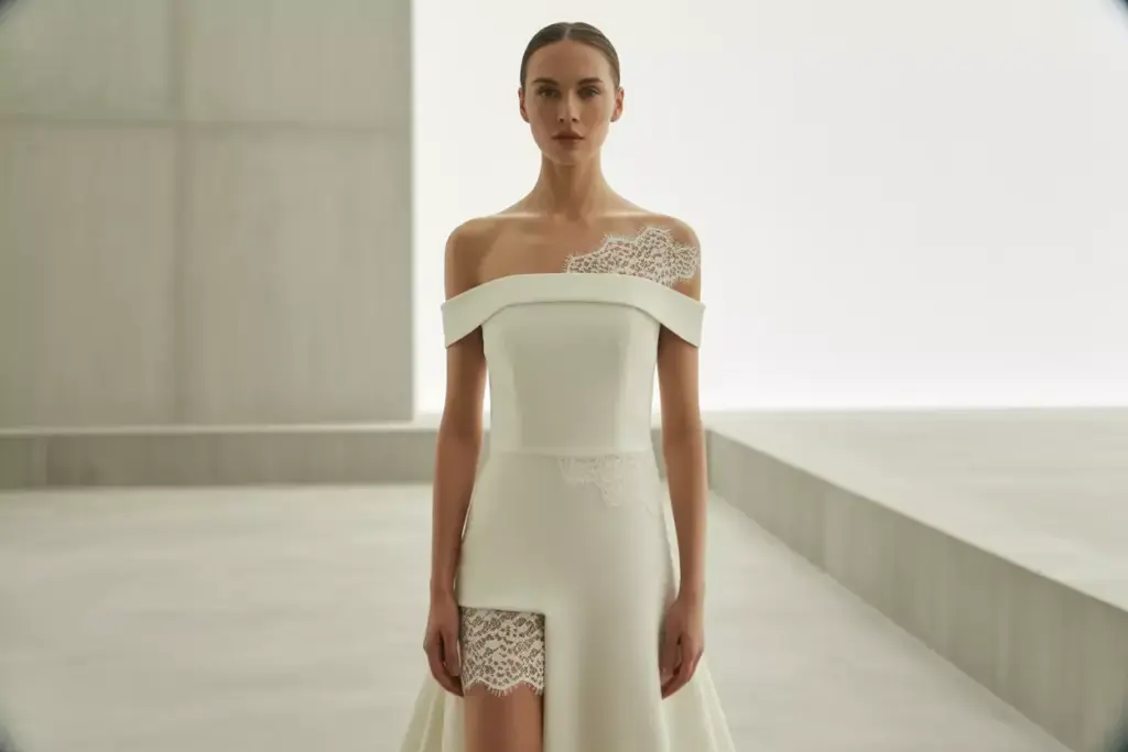 Modern minimalist crepe wedding dress with geometric lace appliques on shoulders