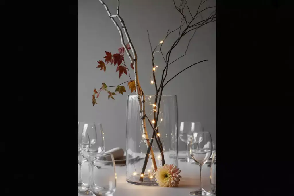 Tall branch arrangement with string lights in clear vase