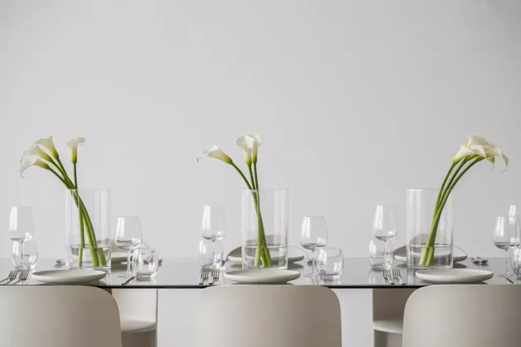 Minimalist clear cylindrical vases single white calla lilies