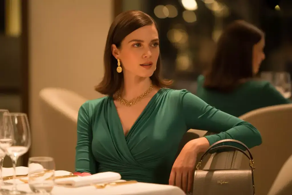 Sophisticated wrap dress at restaurant table with statement jewelry