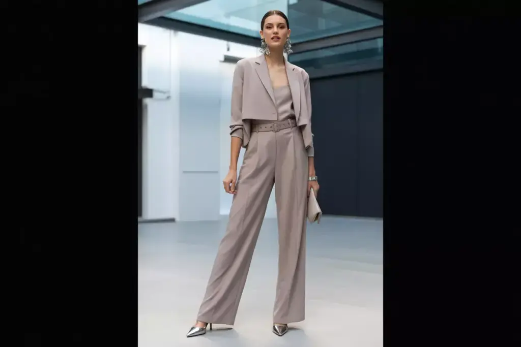 Chic tailored jumpsuit with cropped blazer and statement earrings