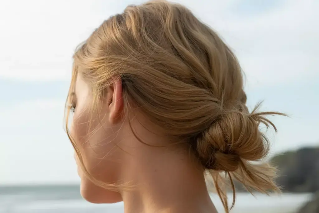 Bohemian textured half up hairstyle with wispy details on beach